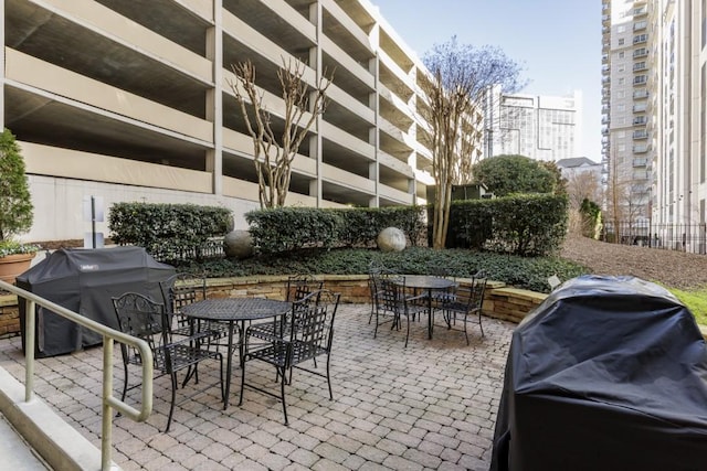 view of patio with outdoor dining area and grilling area