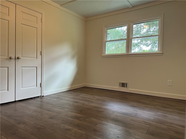 spare room with dark hardwood / wood-style floors