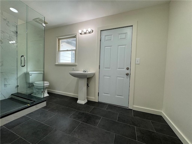 bathroom with tile patterned flooring, walk in shower, and toilet