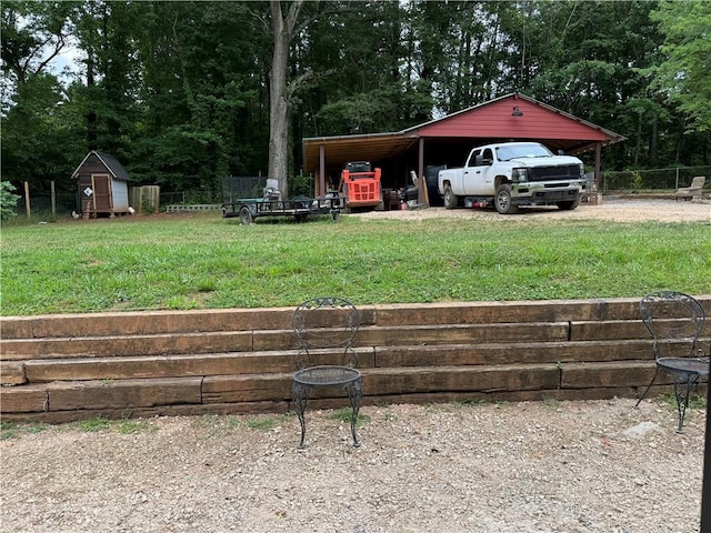 view of yard featuring a carport and a shed