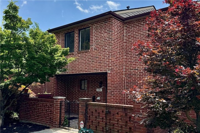 2259 Pernoshal Ct, Dunwoody, GA 30338 - view of side of home with brick siding, a gate, and fence