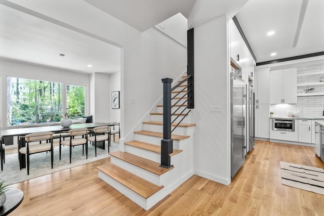 4366 Skyland Dr NE, Atlanta, GA 30342 - staircase featuring recessed lighting, wood finished floors, and baseboards