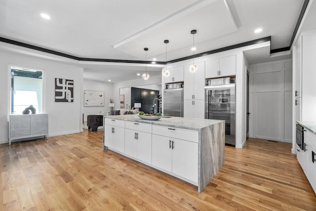 4366 Skyland Dr NE, Atlanta, GA 30342 - kitchen with stainless steel built in refrigerator, an island with sink, wine cooler, and white cabinetry