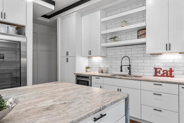 4366 Skyland Dr NE, Atlanta, GA 30342 - kitchen featuring white cabinets, stainless steel appliances, open shelves, and a sink