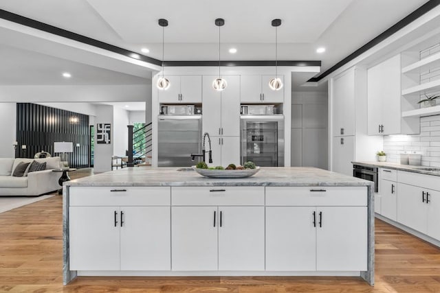4366 Skyland Dr NE, Atlanta, GA 30342 - kitchen with white cabinets, stainless steel fridge, tasteful backsplash, light stone counters, and open shelves