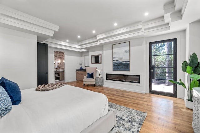 4366 Skyland Dr NE, Atlanta, GA 30342 - bedroom with recessed lighting, a raised ceiling, wood finished floors, and a glass covered fireplace