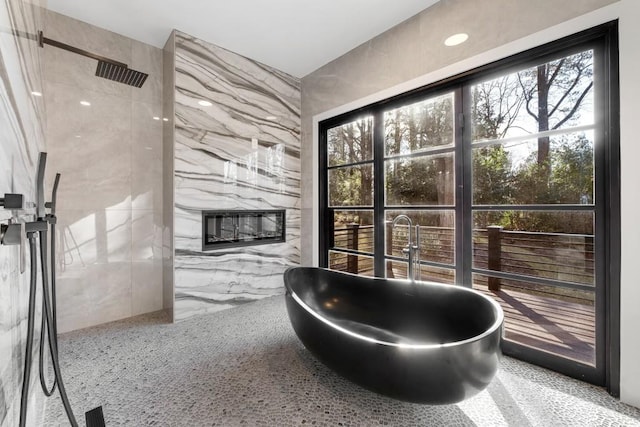 4366 Skyland Dr NE, Atlanta, GA 30342 - full bathroom with tile walls, a freestanding tub, a marble finish shower, and plenty of natural light