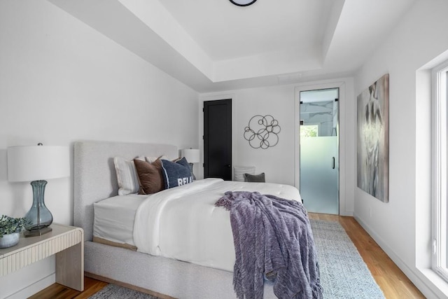 4366 Skyland Dr NE, Atlanta, GA 30342 - bedroom featuring wood finished floors and a raised ceiling
