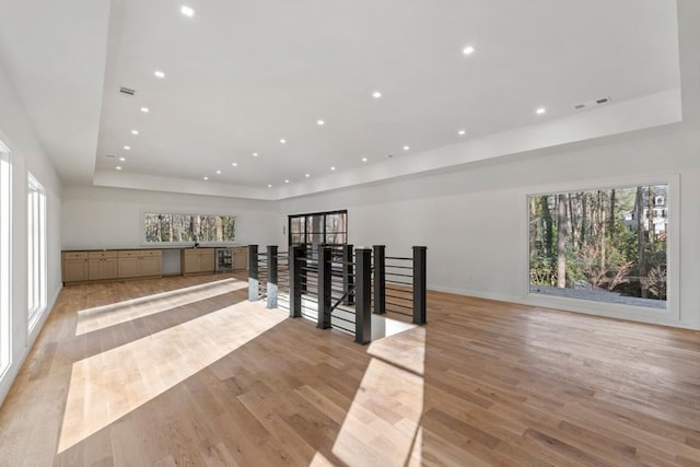 4366 Skyland Dr NE, Atlanta, GA 30342 - hall with light wood finished floors, a wealth of natural light, visible vents, recessed lighting, and a raised ceiling