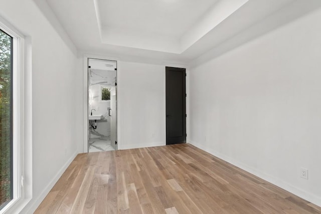 4366 Skyland Dr NE, Atlanta, GA 30342 - interior space with a sink, baseboards, a tray ceiling, and light wood-style flooring