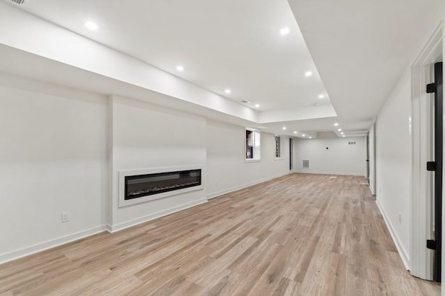 4366 Skyland Dr NE, Atlanta, GA 30342 - unfurnished living room with light wood-type flooring, baseboards, a glass covered fireplace, and recessed lighting