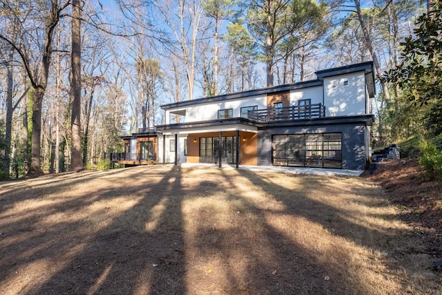 4366 Skyland Dr NE, Atlanta, GA 30342 - back of house featuring stucco siding and a balcony