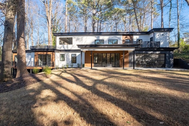4366 Skyland Dr NE, Atlanta, GA 30342 - rear view of property with a garage, a lawn, a deck, and stucco siding