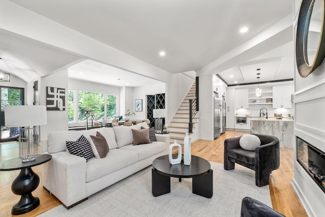 4366 Skyland Dr NE, Atlanta, GA 30342 - living room featuring light wood-type flooring, plenty of natural light, recessed lighting, and stairway
