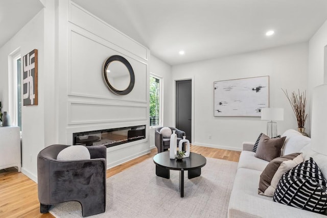 4366 Skyland Dr NE, Atlanta, GA 30342 - living area with baseboards, recessed lighting, a glass covered fireplace, and light wood-style flooring