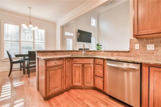 kitchen featuring sink, crown molding, stainless steel dishwasher, and light stone countertops