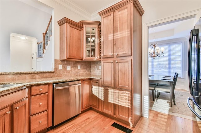 kitchen with tasteful backsplash, light wood-type flooring, fridge, stainless steel dishwasher, and an inviting chandelier