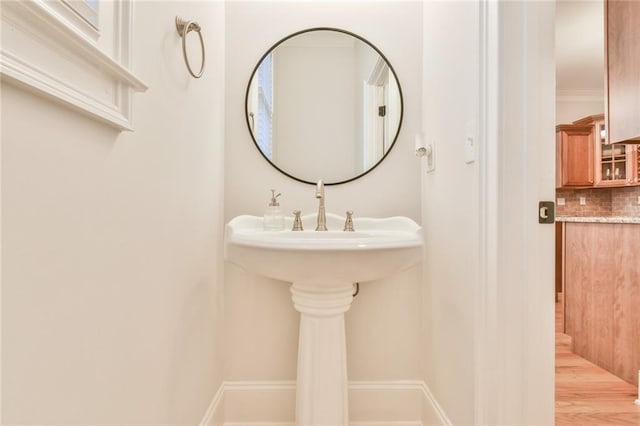 bathroom with backsplash and ornamental molding