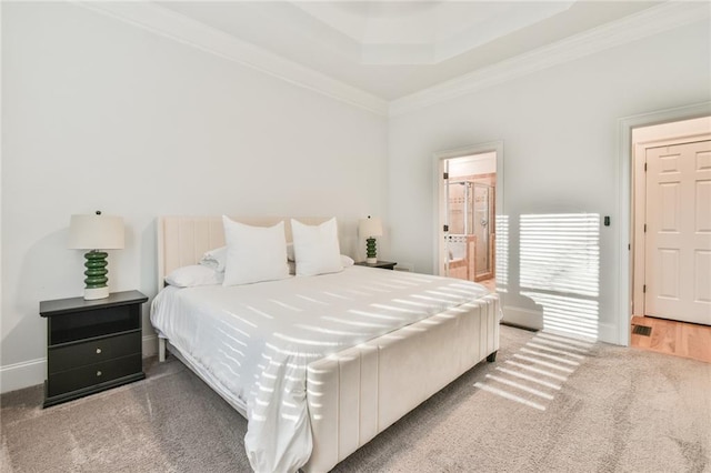 bedroom with crown molding, carpet floors, and ensuite bath