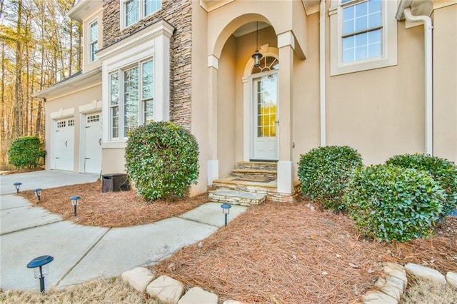 view of exterior entry with a garage