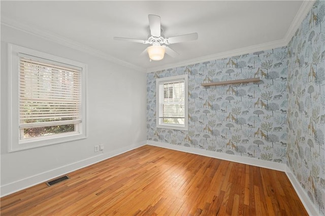 unfurnished room with ceiling fan, ornamental molding, and hardwood / wood-style floors