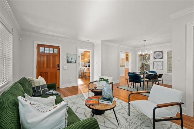 living room featuring ornamental molding, light hardwood / wood-style floors, and a chandelier