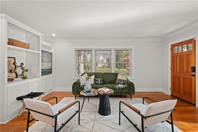 living room with light wood-type flooring and crown molding