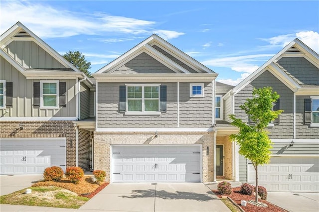 townhome / multi-family property with brick siding and driveway