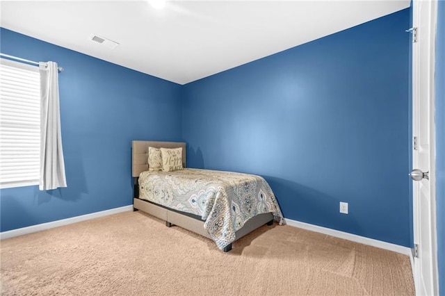 bedroom with carpet flooring, visible vents, and baseboards