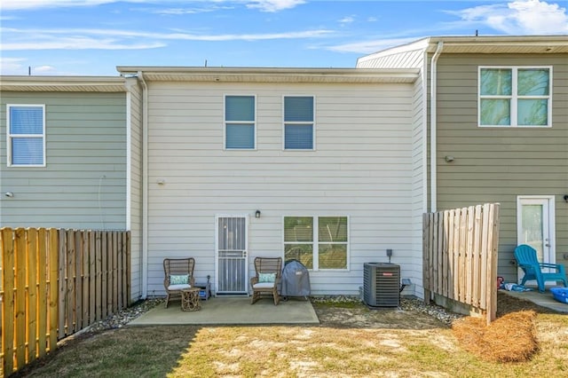 back of house featuring fence, central air condition unit, and a patio area