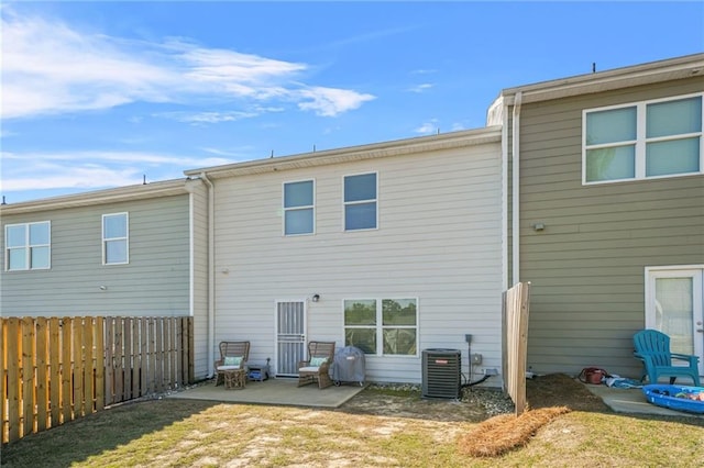 back of house featuring a yard, central AC, a patio area, and fence
