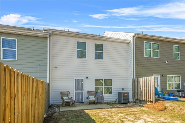 back of property featuring a patio, central AC, and fence