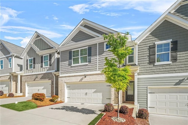 townhome / multi-family property featuring a garage, driveway, and board and batten siding