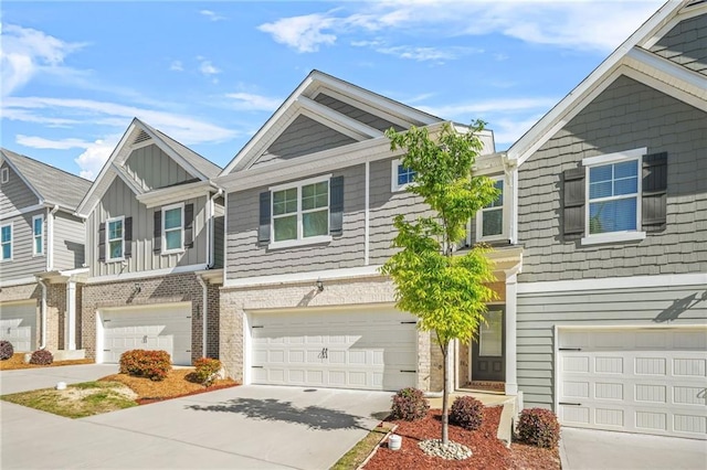 multi unit property featuring concrete driveway, an attached garage, and board and batten siding