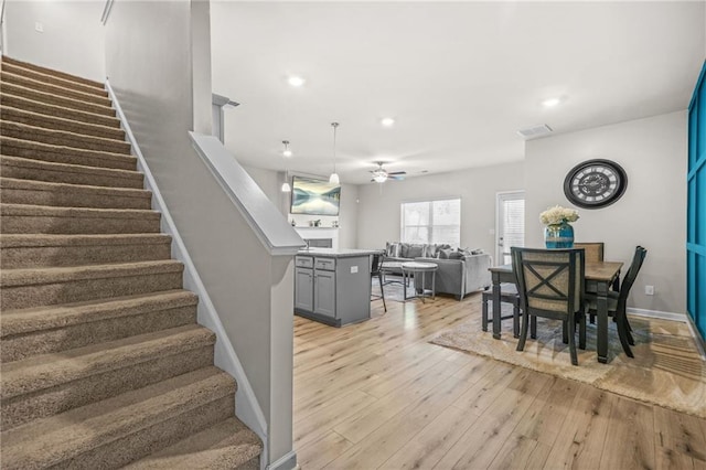 dining area featuring recessed lighting, stairway, light wood-style flooring, ceiling fan, and visible vents
