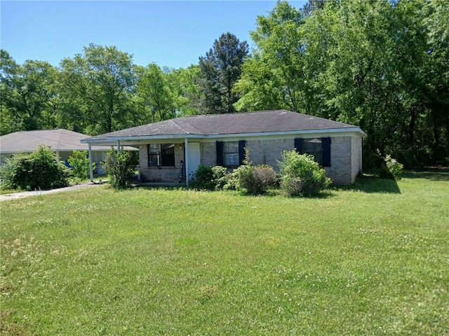 106 Gray St, Atmore, AL 36502 - ranch-style house with a front yard and a carport