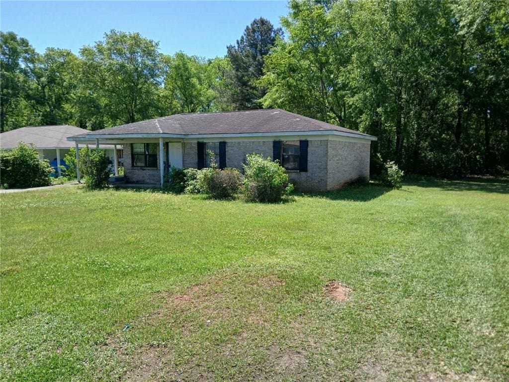 106 Gray St, Atmore, AL 36502 - single story home featuring a front yard