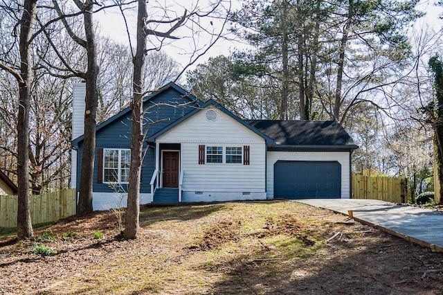 view of front facade featuring a chimney, an attached garage, crawl space, fence, and driveway