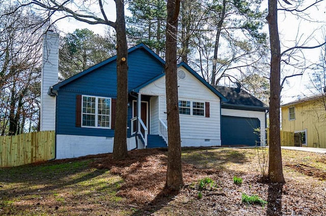 view of front of house with a garage, crawl space, a chimney, and fence