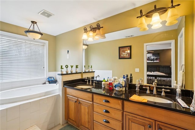 full bathroom featuring a bath, double vanity, a sink, and visible vents