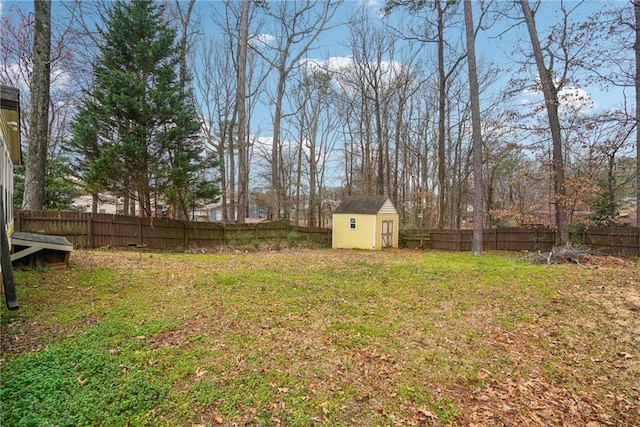 view of yard featuring a storage shed, a fenced backyard, and an outdoor structure