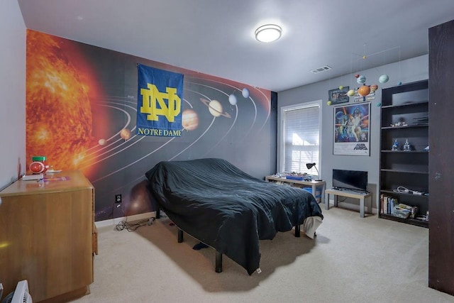 carpeted bedroom featuring baseboards and visible vents