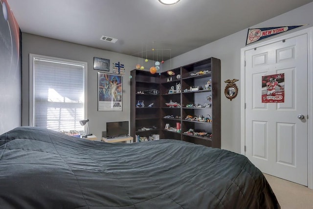 bedroom with visible vents and carpet flooring