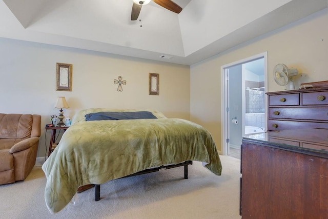 bedroom with visible vents, ensuite bath, carpet, baseboards, and vaulted ceiling