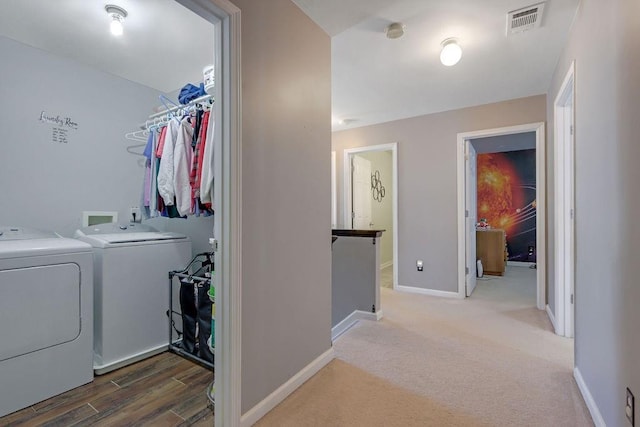 laundry area featuring washer and clothes dryer, laundry area, baseboards, and visible vents