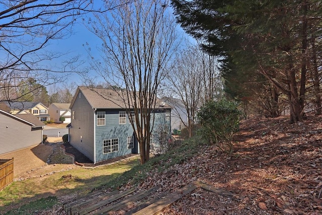 view of side of property featuring fence