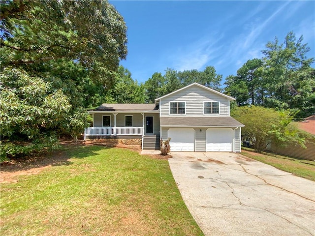 split level home featuring covered porch, a garage, and a front lawn