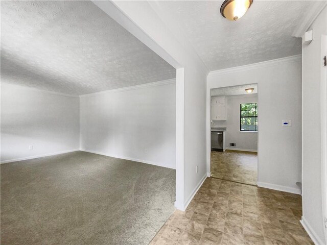 spare room with light tile patterned floors, ornamental molding, and a textured ceiling