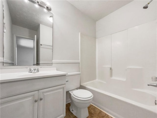 full bathroom featuring shower / bathing tub combination, vanity, tile patterned floors, a textured ceiling, and toilet