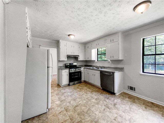 kitchen featuring sink, stainless steel appliances, a healthy amount of sunlight, and light tile patterned floors